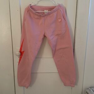 Starfit pink sweatpants with orange lighting bolt